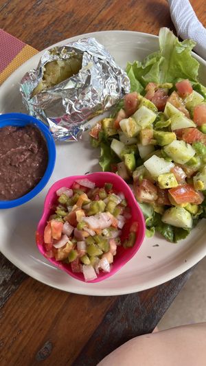 Avocado salad, beans, baked potatoes and salsa salad  at Eva's Cafe and Bar at Mango Inn in Utila