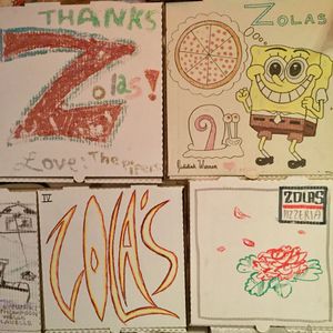 painted pizza boxes on the walls : ) at Zola's Pizzeria in Brookings