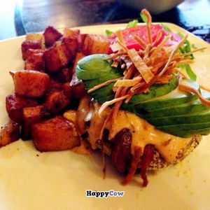 GREEN LENTIL & GREEN CHILI BURGER: Corn meal crusted vegetable burger made with green lentils, green chilies,red onion, cilantro, quinoa and roasted corn. Topped with chipotle aioli, avocado, shredded romaine, and crisp tortilla strips. w/ Rice bread at Great Sage in Clarksville