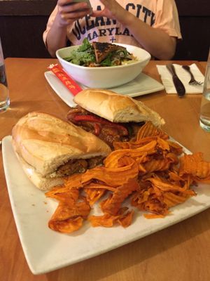 Sausage Sub -- House-made vegan sausage with molé sauce, sautéed peppers & onions and sweet potato chips on the side  at Great Sage in Clarksville