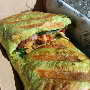 Vegan falafel wrap - vegan feta, aioli, falafel, greens, misc marinated veggies and onion! at 1 in 20 in The Basin