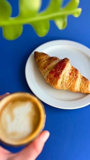 Vegan raspberry croissant and cafe con leche  at Café Fadrí in Cambrils