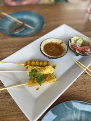 Tofu satay skewers (three skewers already eaten!). The sauce is heavenly    at Little Moon Dine and Cafe in Trat