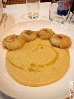  an Italian specialty: roasted flat onions, served on a bean purée, very original. at Il Lughino in Milan
