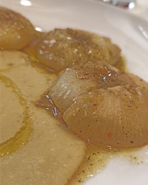  an Italian specialty: roasted flat onions, served on a bean purée, very original. at Il Lughino in Milan