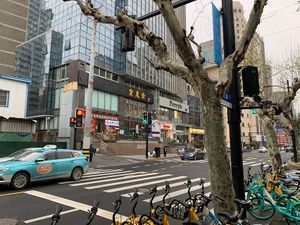 Outside. The restaurant is below the yellow letters (above traffic light )  at Huì Yuán Sù Shí Fāng 慧缘素食坊 Lotus Vegan in Shanghai