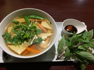 [image description: a colour photo of a bowl of pho on a long plate. beside the bowl is a small bowl with sauces and a bunch of basil. end description.]

Vegetarian Pho - $8.75 (as of October 2014)

absolutely delicious at Veggiebowl in Vancouver