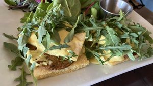 Southern benedict - cornbread, sausage patty, tofu, creole hollandaise sauce and arugula 💯 at Tree House in St Louis