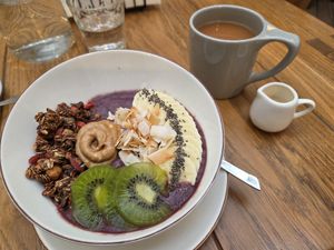 Acai bowl with breakfast tea and oat milk at 718 Breakfast & Brunch in Sofia