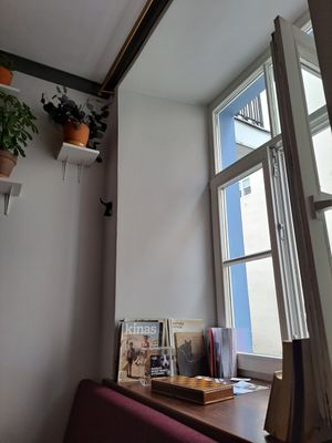 Cute indoors, many plants and books at Vieta in Vilnius