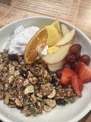 Muesli with homemade granola, coconut yogurt and fresh fruit. Served with a side of oat milk.   at Thatcher & Small in Hokitika