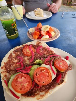 Breakfast baleada, sort of an open face burrito w fresh ripe fruit bowl total $5  at Yahongreh? in Roatan
