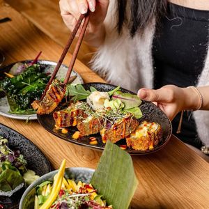 Crunchy roll, filled with steamed sweet potato, avocado, mango, cucumber, and radish, topped with homemade teriyaki mayo at Vilai Vegan House in Hamburg