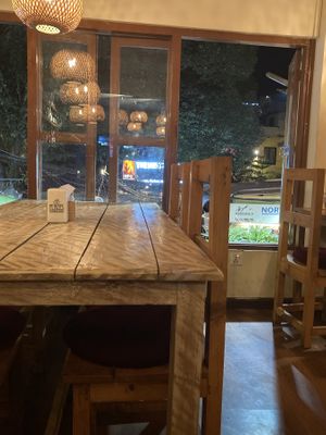 The interior: Wooden tables and large windows  at Places Restaurant and Bar in Kathmandu