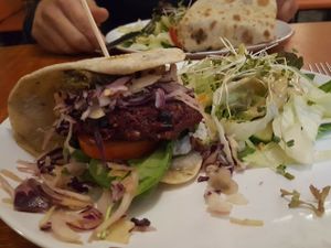 vegan beetroot burger with salad and vinaigrette dressing at Vegtral Restaurace in Prague