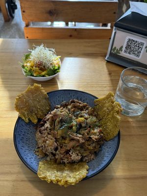 Rice and beans, mixed with seitan, mushrooms, and veggies, with tostones as a nice addition and served with a refreshing mango salad   at Arbol de Seda in San Jose