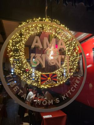 Window sign at Ama Tibetan Mom's Kitchen in Bruges