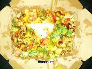 These are the vegan jerk fries. It was loaded with goodness! Fries, spinach, homemade sauce, avocado, tomatoes, bell pepper, seasoning, and topped with veganaise. at Ready Veggie in San Diego