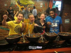 The owner, Gustavo Millán, (left) drags gringo customers behind the serving line for a photo op with staff. at Tacos Gus in Mexico City