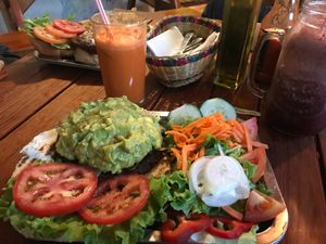 Guacamole black bean burger on an arepa with a side salad. at Brunch de Salento in Salento