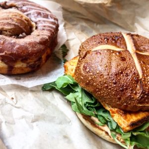 The curry tofu samich—instead of paying a bit more to upgrade it to a bowl, I bought a donut!! The peanut butter cookie dough doughnut! So delicious!!!  at The Cinnamon Snail in New York City