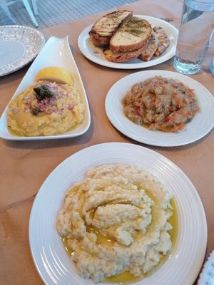 Range of cold appetizers including fava with onions and capers, skordalia, and Greek eggplant dip at To Kare Tou Meze - Το Καρέ του Μεζέ in Itea