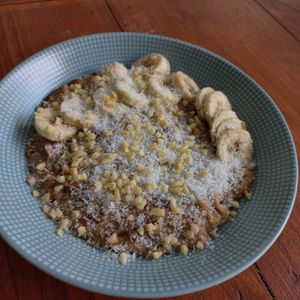 Classic oatmeal with banana, chia seeds, coconut, dates, sprinkle with diced almond and dried coconut at O Baba Vegan in Denpasar