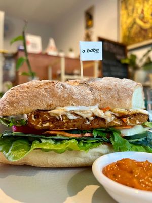 A big sandwich with good stuff in it, yummy 😍 at O Baba Vegan in Denpasar