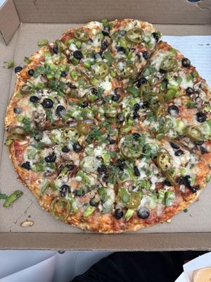 Large Jalapeños, Black Olives and Mushrooms made vegan with plant based Cheeze  at Mr Singh's Pizza in Brampton