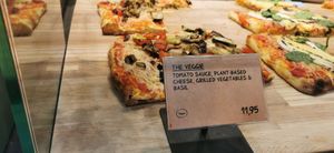 Thick soft crust pizza with vegan cheese topped with veg at AMS - The Oven  in Schiphol