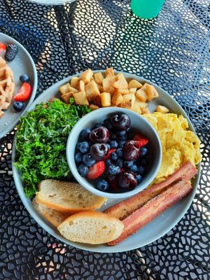 "Breakfast Plate":JustEgg, cherries & berries, steamed kale, potatoes, garlic toast, choice of faux bacon or sausage at 3 Howls Remedy House in Vancouver