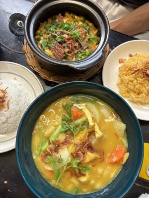 Yellow curry (bottom) & pumpkin tempeh clay pot (top)  at Mingle Cafe in Hue