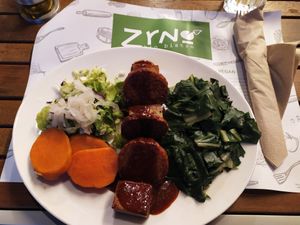 Mega proteine plate: grilled tempeh and farmmade tofu & seitan with BBQ sauce, green vegetables and cooked sweet potato. at Zrno Bio Bistro in Zagreb