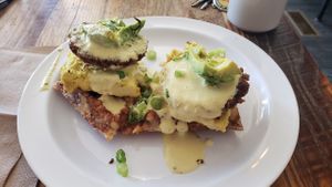 Benedict Latkes! (fried potato cake topped with tofu egg, vegan hollandaise sauce, sausage patty, avocado. at Lulu's Local Eatery in St Louis