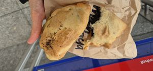 Empanada with vegetables to the left and spinach to the right. at M-Panada  in Zurich