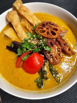 Creamy tahini curry noodles with vegetables and fried tofu skin. at Our Sunny Workshop in Kyoto
