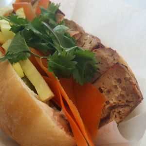 Bahn Mi with baked tofu, Bacon Seitan, pumpkin seed pate, jalapeños, carrots, radish, cilantro. at Liberation Kitchen in Chicago