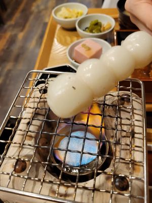 Cooking sticky rice balls at Komaki Shokudo in Tokyo