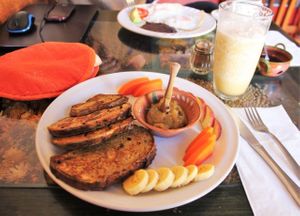 French toast with apple jam and fruit. Banana smoothie blended with water/ice in the background. at Xiguela Cafe in Oaxaca