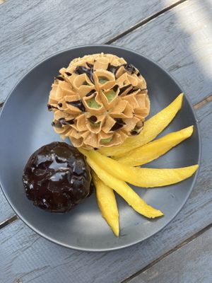 Vegan desert I designed - tamarind chocolate brownie, pandan coconut sticky rice and fresh mango with a crunchy local flower crisp   at The Trio Bar in Nong Khiaw