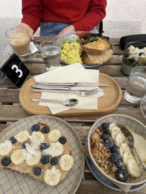 Peanut Butter Toast, Bowl of Yogurth and Big Brealfast with two Coffee’s with (Oat) milkk  at Piccola Cafe in Ljubljana