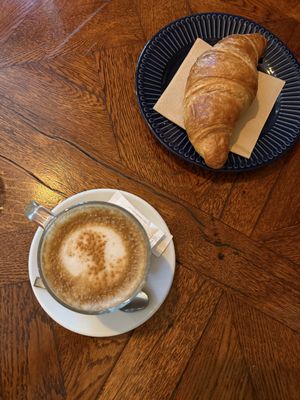 dirty chai latte and plain croissant   at Piccola Cafe in Ljubljana