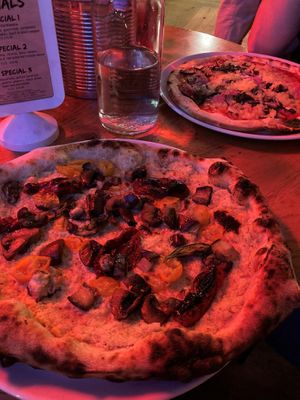 my artichoke-based pizza with mushrooms, basil, peppers, tomatoes and additional aubergine.  In the back my mum's gluten-free pizza with vegan cheese. at Sano in Glasgow