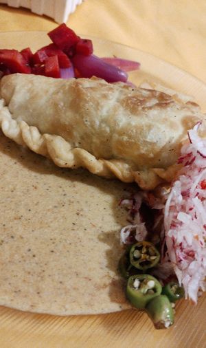 Peanut sauce with chile, radish, and empanada at Raul in Cochabamba