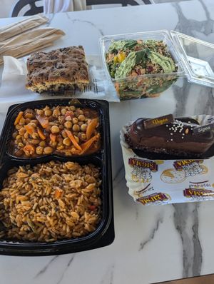 Pre-made salad, vegan dessert, olive bread and combo from vegan hot foods counter at Sigma Bakeries in Ayia Napa