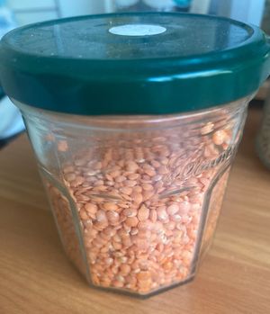 Reused jar with weight containing on sticker  red lentils bought here   at La Petite Épicerie Nyc in New York City