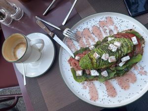 Latte with almond milk and avocado toast with feta  at Eathica Eatery in Ankara