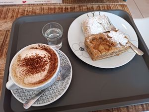 Vegan cake and oat cappuccino at Batidor Pasteleria in Fisterra