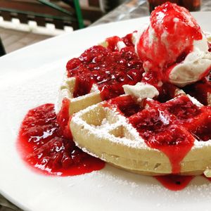 Kinda dry waffles with ice "cream" and warm raspberries at Creperie Lamara in Hannover