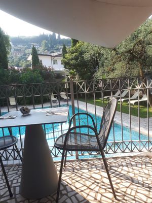 Sitting area outside by the pool at Gabry in Riva Del Garda